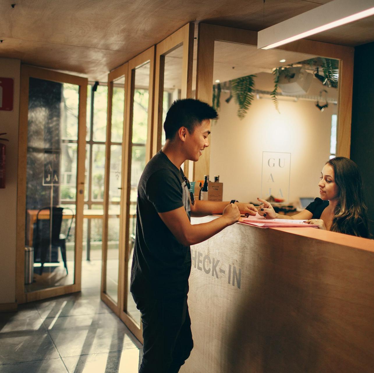 man in black shirt standing beside counter